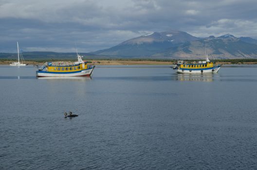 Magallanes and Chilean Antarctic Region. Chile. January 28, 2012: tourist boats in the Ultima Esperanza Inlet and Sarmiento Mountain Range.
