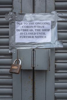 A Sign Outside A High Street Store Saying Closed Due To Coronavirus Outbreak