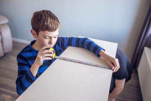 Hobby, carpentry, woodwork, craft, skill concept - boy making constructing assembling furniture at home