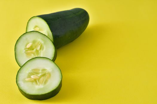 sliced ​​cucumber on yellow background