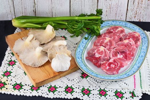 sliced raw lamb neck and mushrooms