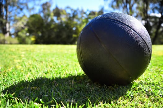 A black medicine ball on grass