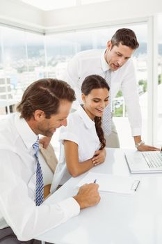 Three young business people in meeting at office