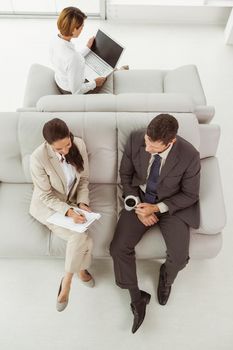 Hgh angle view of young business people on couch