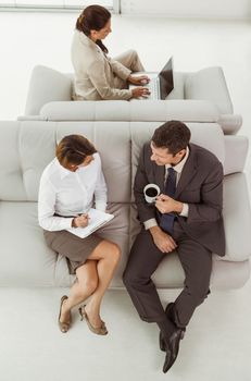 High angle view of young business people on couch