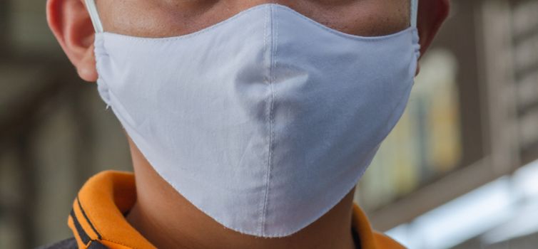 Asian men wear white virus masks.