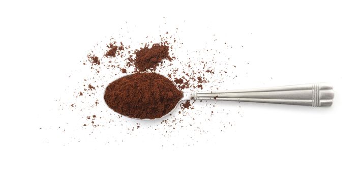 Сoffee powder on spoon isolated on white background