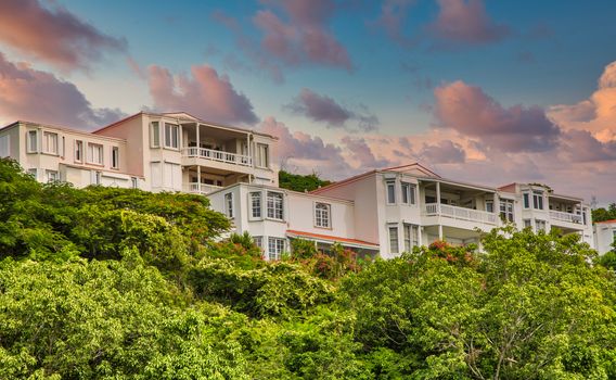 Resort homes on green hillsdie in the tropics