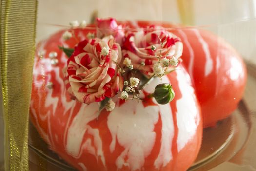 Mousse cake in the shape of heart with small roses, cake in transparent box