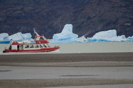Tourist boat and icebergs on Grey Lake. Torres del Paine National Park. Magallanes and Chilean Antarctic Region. Chile.