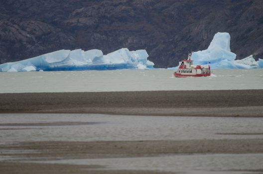 Tourist boat and icebergs on Grey Lake. Torres del Paine National Park. Magallanes and Chilean Antarctic Region. Chile.