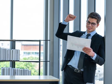 Businessmen in suits and tie are happy with this quarter's sales evaluation results. Morning work atmosphere In a modern office.