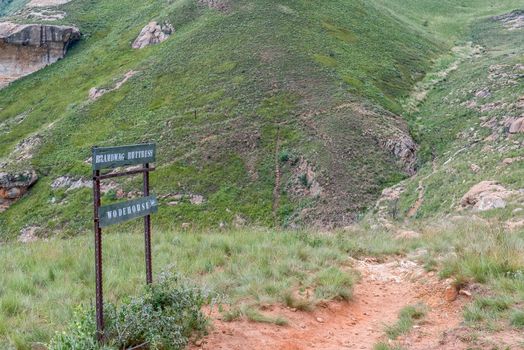 Sign on top of the Brandwag buttress at Golden Gate. The trail leading down to the hotel is visible