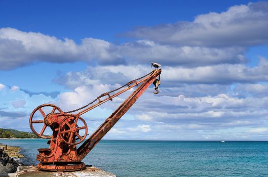 An old rusty, red crane on the island of St Croix