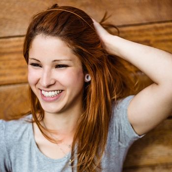 Portrait of a cheerful pretty redhead laughing in the city