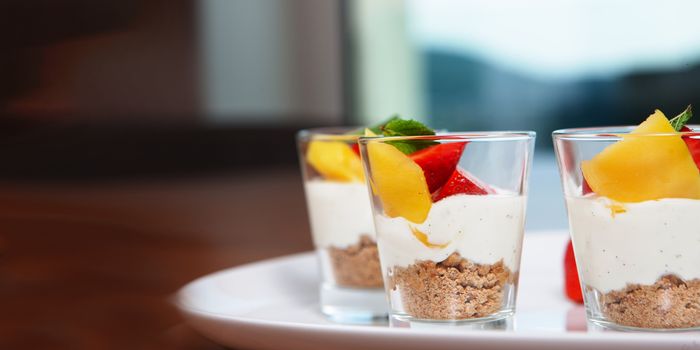 white plate with strawberries and mango. Lifestyle food served in glasses