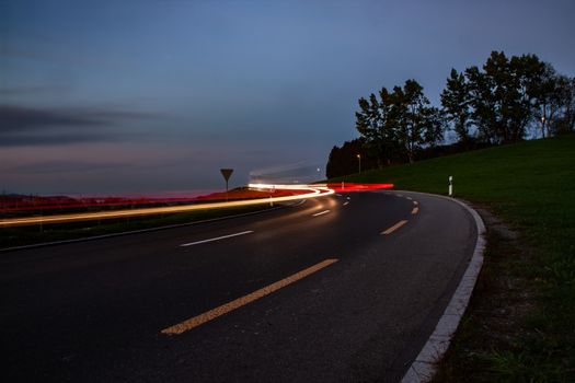 streaks of car lights during sun down in Switzerland