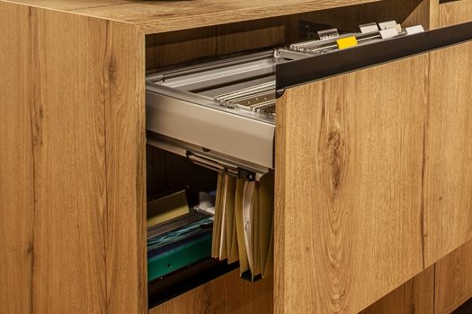 wood filing cabinet with folders. Archives