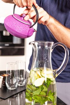 fresh drink prepared with water by a cook with hands