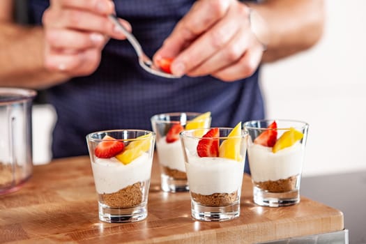 white plate with strawberries and mango. Lifestyle food served in glasses