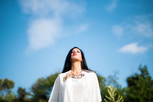 Happy dreaming woman enjoying the life in the field. Nature beauty, colorful field, fashion woman. Outdoor lifestyle. Freedom concept