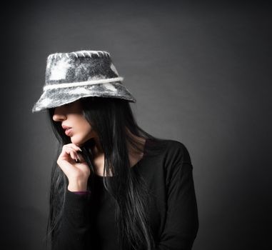 Elegant woman in hat are thinking 