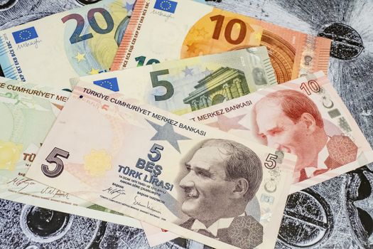 close up turkish lira banknotes with euro bankmotes on background