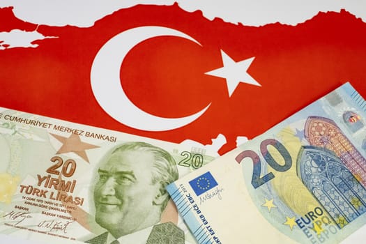 close up turkish lira banknotes with euro bankmotes on background