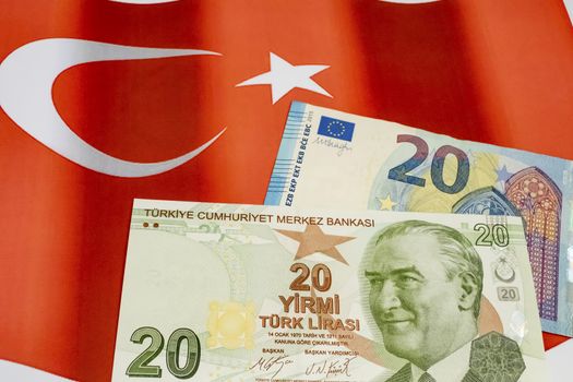 close up turkish lira banknotes with euro bankmotes on background