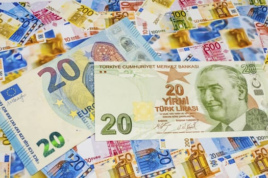 close up turkish lira banknotes with euro bankmotes on background