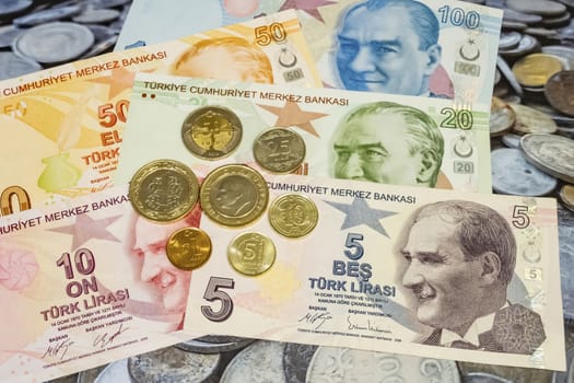 close up turkish lira banknotes with turkish metal coins on background