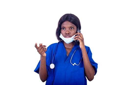 beautiful astonished young woman, doctor in uniform talking on mobile phone