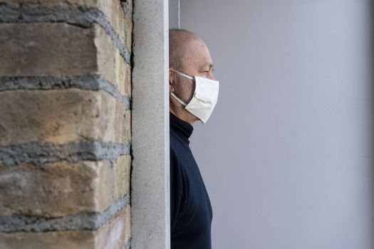 a man who leaves home with a protective mask over his mouth during the coronavirus pandemic