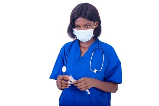 beautiful young female doctor in uniform holding a syringe in hand.