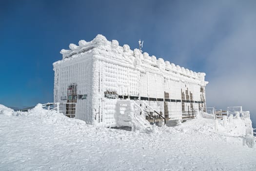 Post office called Postovna on top of Snezka covered with frost. The peak of the Snezka Mountain in winter in the Krkonose Mountains.