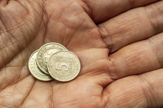 close up turkish metal coins on hand