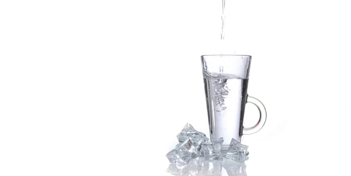glass of fresh clear water with ice on white background