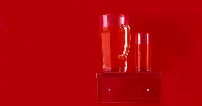 plexiglass display with fluids with red drinks and red background