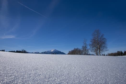 clear blue sky with snow in the mountains of Switzerland, Zugerberg. Trees and mountains