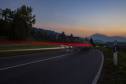 head and back lights with long exposure causing long light streaks. Twilight