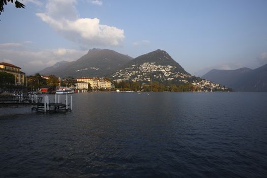 Water front with view of Lugano city and lake, Switzerland with lake and mountains