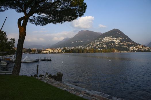 Water front with view of Lugano city and lake, Switzerland with lake and mountains