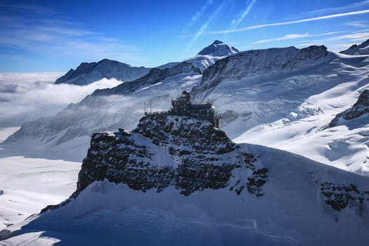 Three famous Swiss mountain peaks, Eiger, Mönch and Jungfrau, with observatory on top.