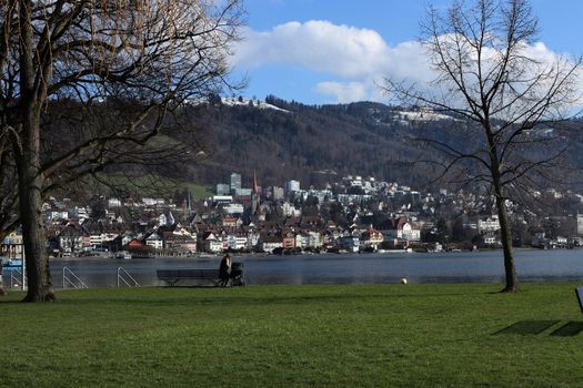 calm scene in park in Zug, Switzerland, lake Zug and city