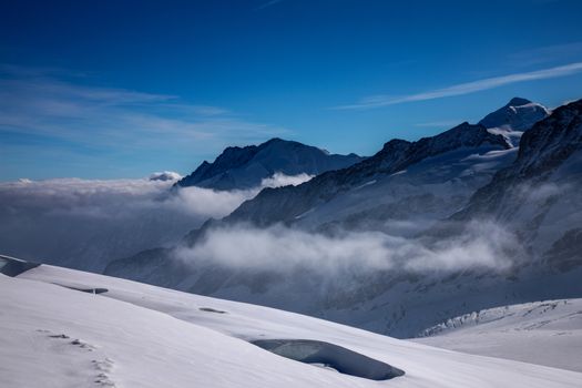 Jungfraujoch - up in the mountains, with snow, blue sky and mountains