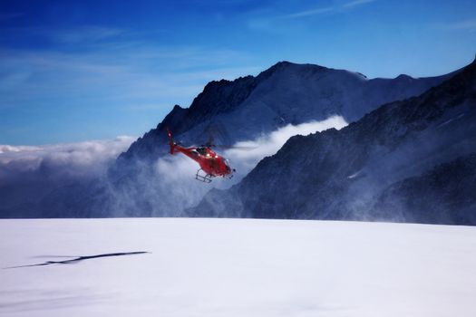 Jungfraujoch - up in the mountains with a helicopter taking off