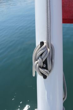 boat - rope.- water and part of swiss flag and blue - green water