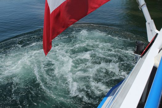 boat - rope.- water and part of swiss flag showing