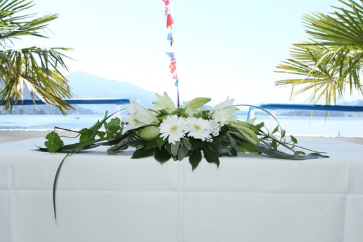 wedding flowers on a boat with the hat of the captain