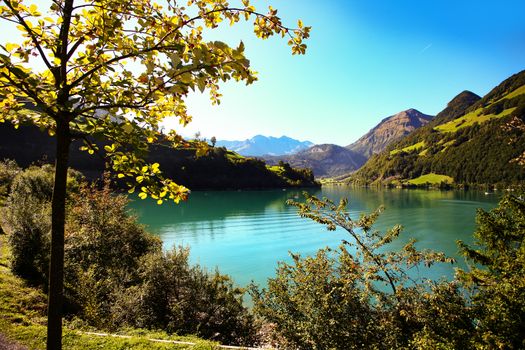 lake lungern Switzerland - famous fishing lake in Switzerland. trees and reflection by lake